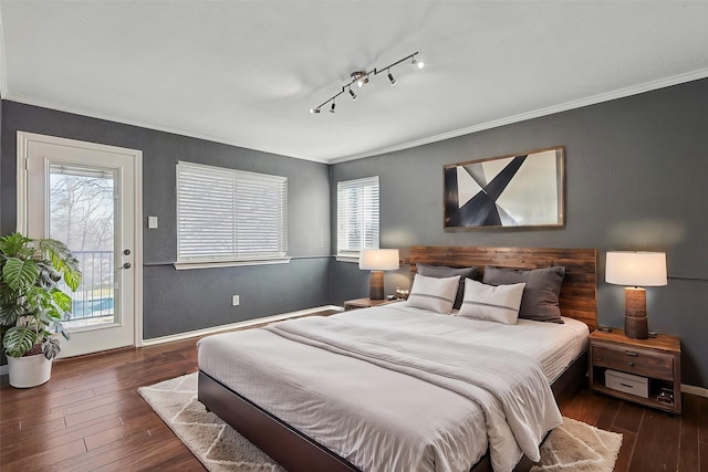 bedroom with baseboards, wood-type flooring, crown molding, and access to outside