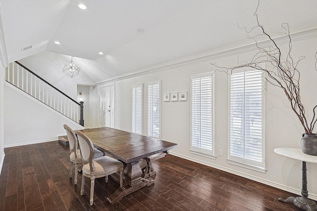 dining area featuring an inviting chandelier, ornamental molding, lofted ceiling, and wood-type flooring