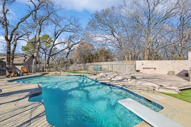 view of pool featuring a fenced in pool, a patio, a fenced backyard, and a diving board