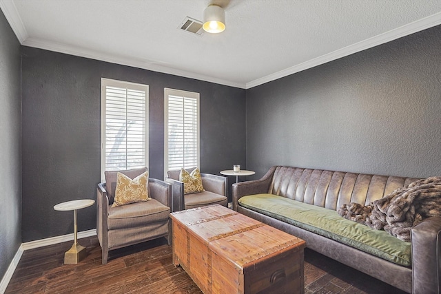 living room with visible vents, crown molding, baseboards, dark wood-type flooring, and a textured wall