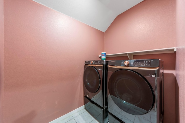 laundry area featuring separate washer and dryer and light tile patterned floors