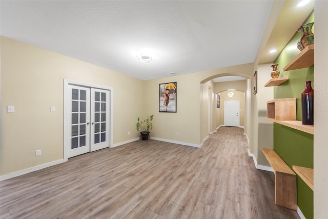 unfurnished room featuring light hardwood / wood-style flooring and french doors