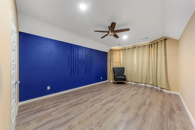 unfurnished room with ceiling fan, vaulted ceiling, and wood-type flooring