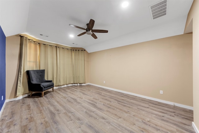 unfurnished room with ceiling fan, lofted ceiling, and light hardwood / wood-style flooring