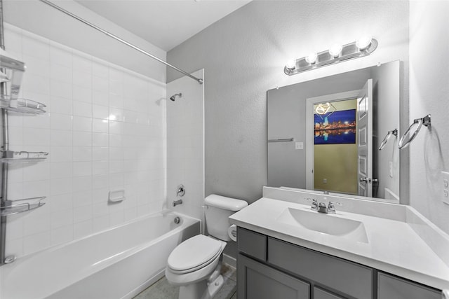 full bathroom featuring tiled shower / bath combo, vanity, and toilet