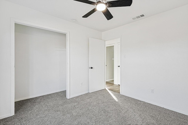 unfurnished bedroom featuring carpet flooring, ceiling fan, and a closet