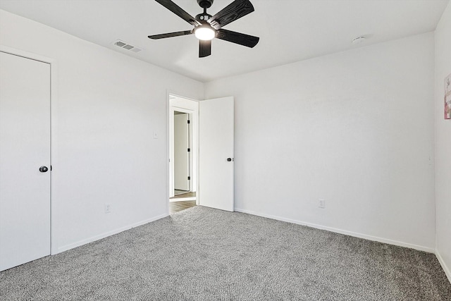 unfurnished bedroom with carpet floors, ceiling fan, and a closet