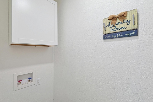 laundry room with hookup for a washing machine and cabinets