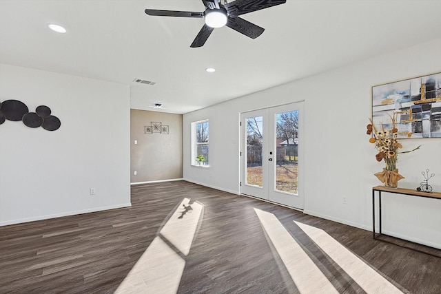 empty room featuring dark hardwood / wood-style flooring, french doors, and ceiling fan