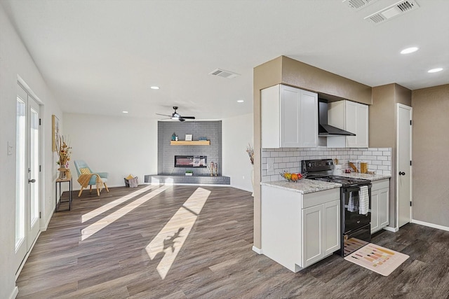 kitchen featuring white cabinetry, black electric range oven, dark hardwood / wood-style floors, and wall chimney exhaust hood