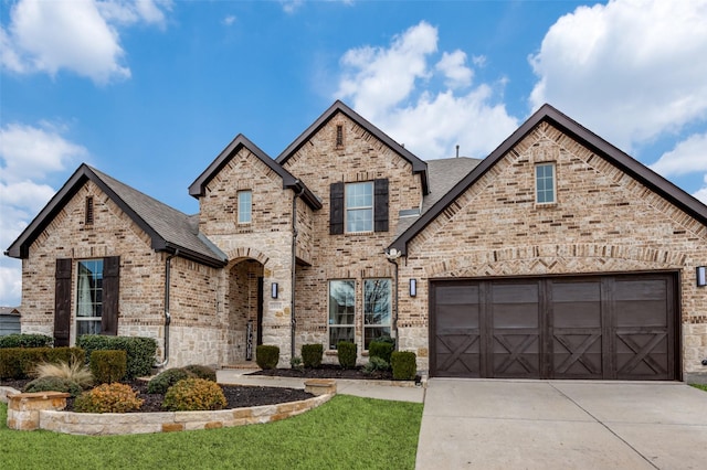 view of front of home featuring a garage and a front lawn