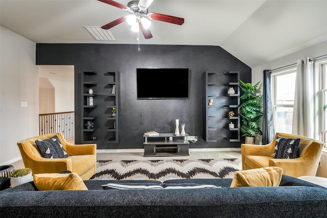 living room featuring vaulted ceiling, built in features, and ceiling fan