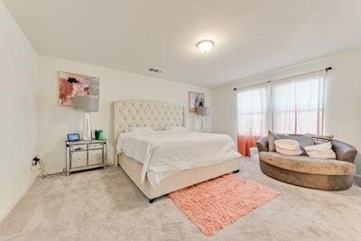 bedroom featuring light colored carpet