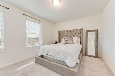 bedroom featuring light carpet