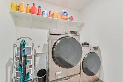 laundry room featuring washing machine and clothes dryer