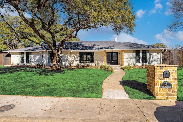 ranch-style home featuring a front yard