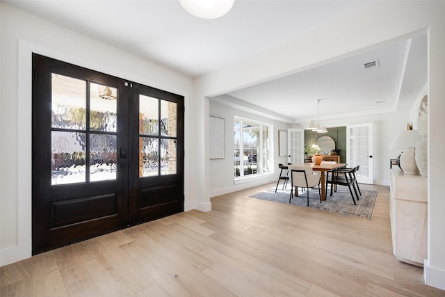 foyer with french doors and light wood-type flooring