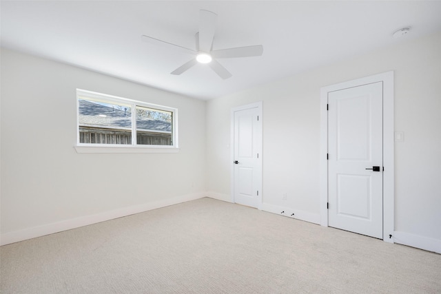 unfurnished bedroom featuring ceiling fan and light colored carpet