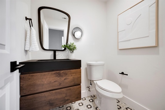 bathroom with vanity, tile patterned flooring, and toilet