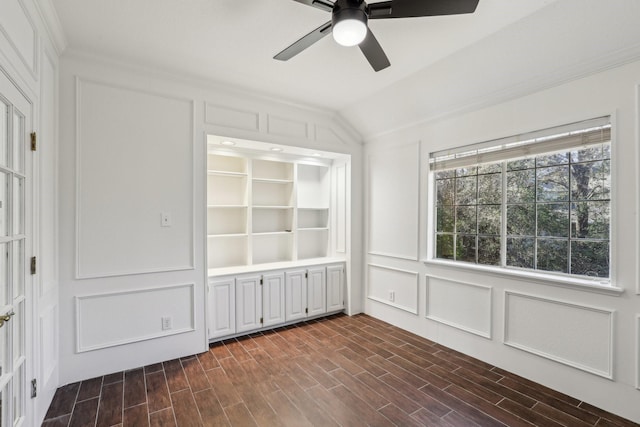 interior space with built in shelves, ceiling fan, and lofted ceiling