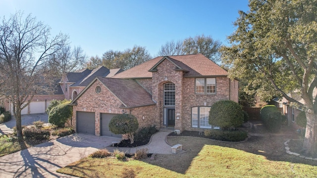 view of front property featuring a garage and a front lawn