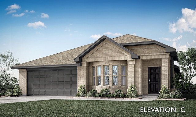 view of front of property featuring a garage and a front yard