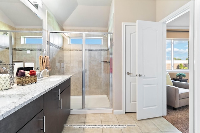 bathroom with an enclosed shower, vanity, tile patterned flooring, and vaulted ceiling