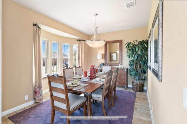 dining space with hardwood / wood-style floors