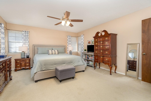 bedroom featuring light colored carpet and ceiling fan