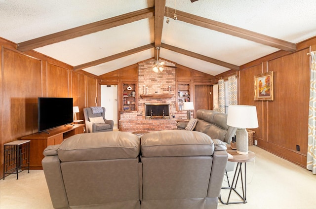 living room with ceiling fan, light colored carpet, a fireplace, and wooden walls