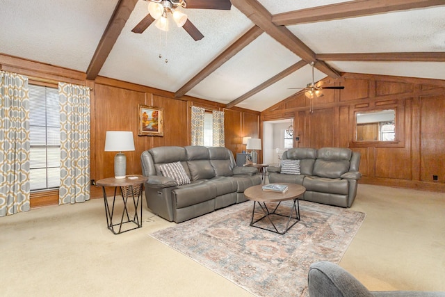 carpeted living room featuring ceiling fan, wooden walls, a textured ceiling, and vaulted ceiling with beams