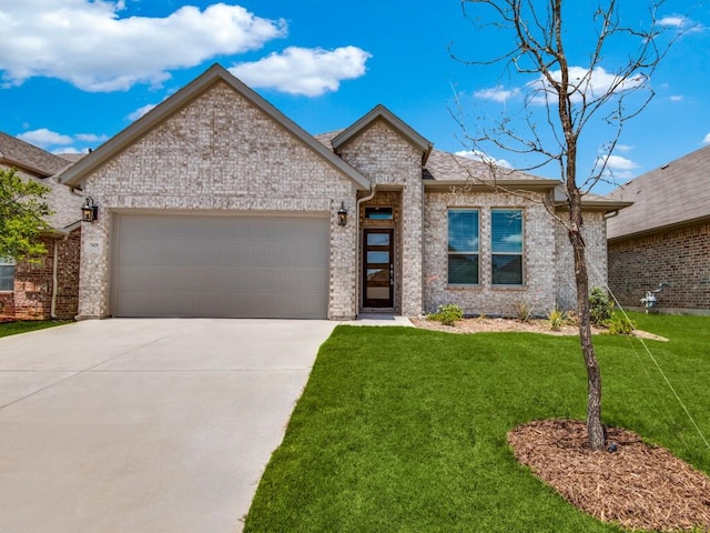 view of front of home with a garage and a front yard