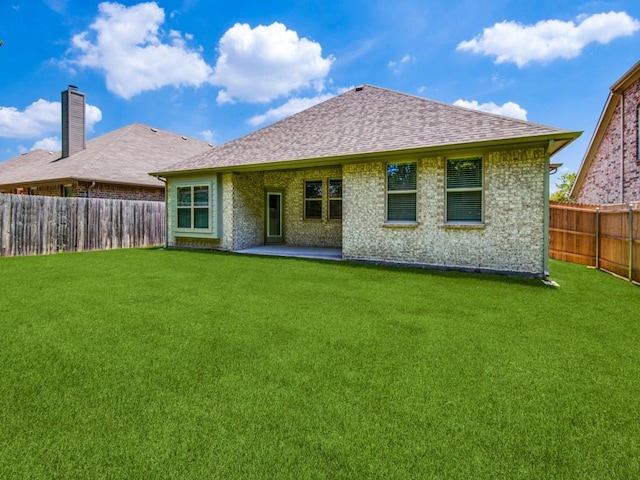 back of house with a yard and a patio area