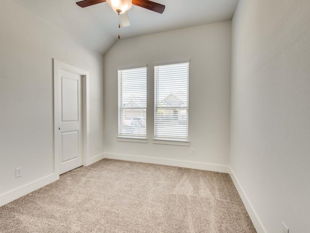 carpeted empty room with lofted ceiling and ceiling fan