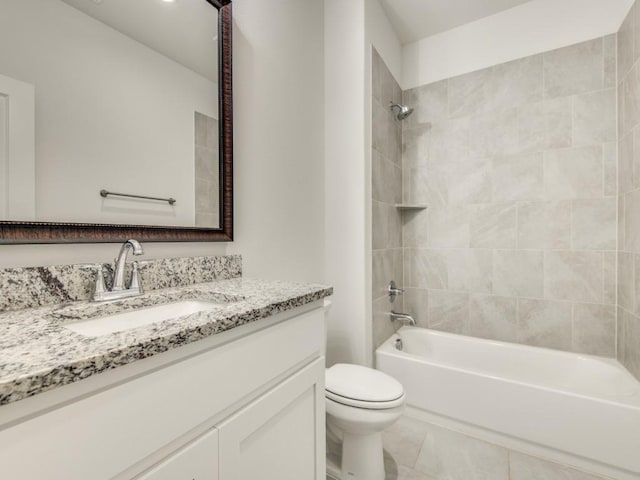 full bathroom with tiled shower / bath, vanity, toilet, and tile patterned floors