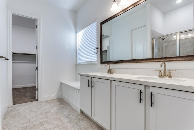 bathroom with vanity and a shower with door