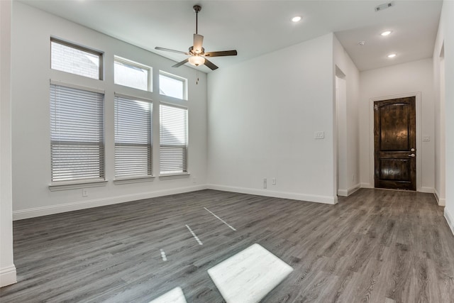 empty room featuring dark hardwood / wood-style floors and ceiling fan