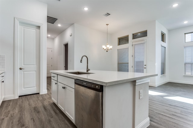 kitchen featuring decorative light fixtures, white cabinetry, sink, a kitchen island with sink, and stainless steel dishwasher