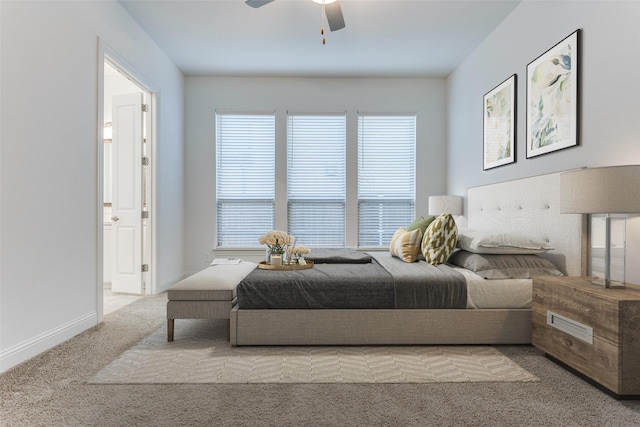 bedroom with multiple windows, light colored carpet, and ceiling fan