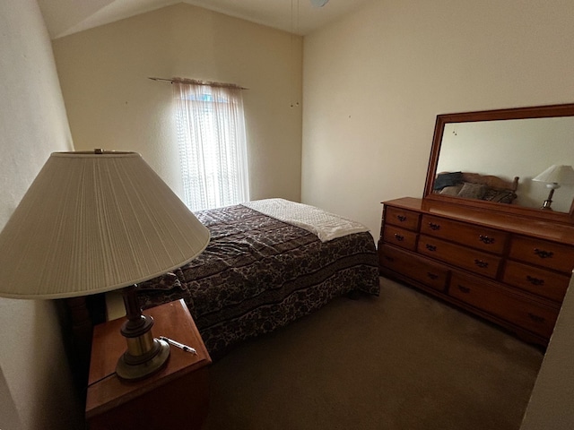 bedroom featuring vaulted ceiling and dark colored carpet