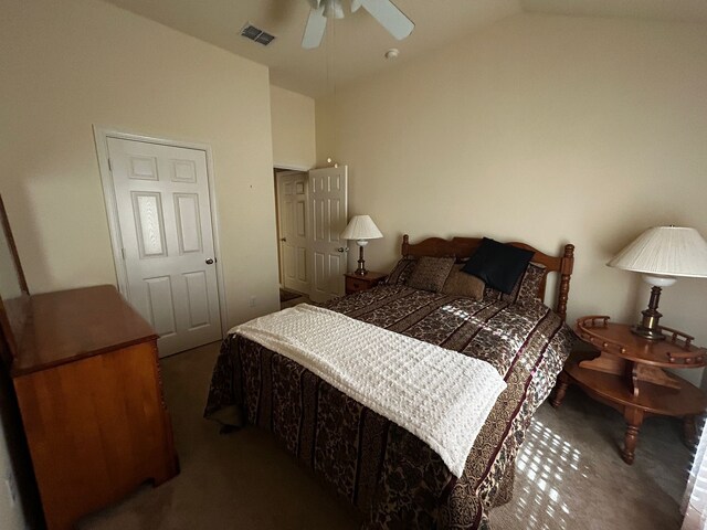 bedroom with ceiling fan, lofted ceiling, and dark carpet