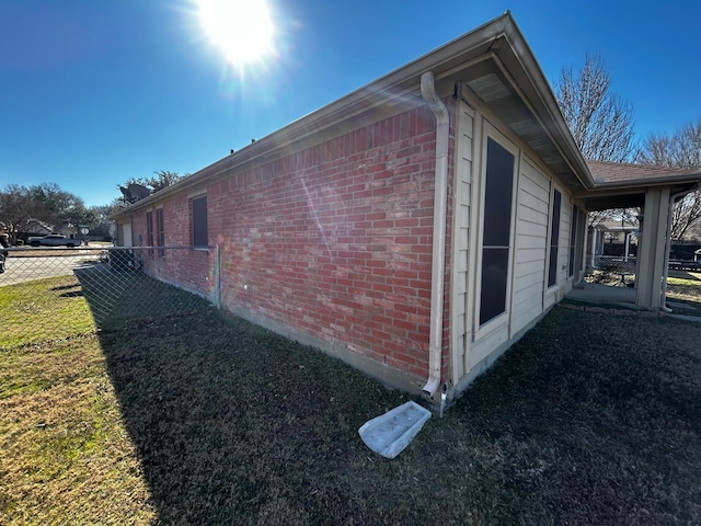 view of side of property with a yard