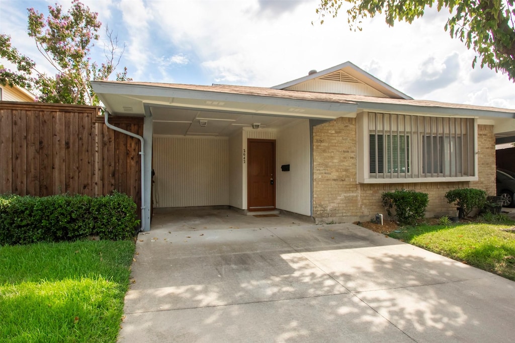 ranch-style home featuring a carport