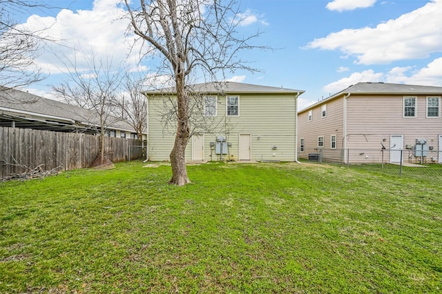 back of house featuring a yard