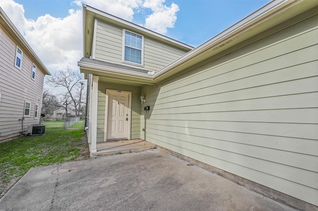 doorway to property with central AC and a patio area