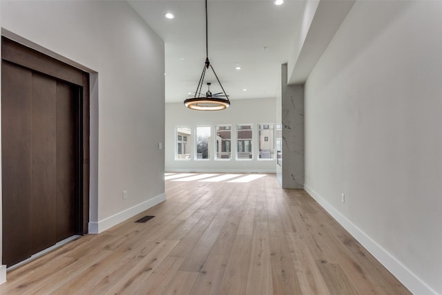 unfurnished dining area with visible vents, recessed lighting, baseboards, and light wood-style floors