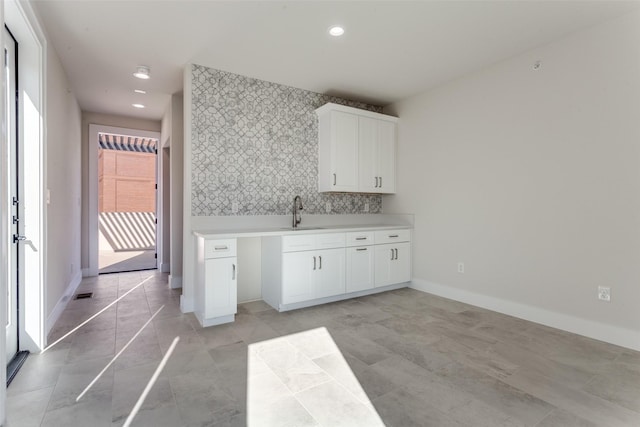 kitchen with recessed lighting, baseboards, light countertops, and white cabinetry