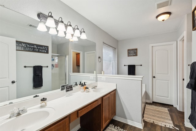 bathroom featuring hardwood / wood-style flooring, vanity, and separate shower and tub