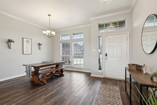 entrance foyer with dark hardwood / wood-style flooring, a notable chandelier, and ornamental molding