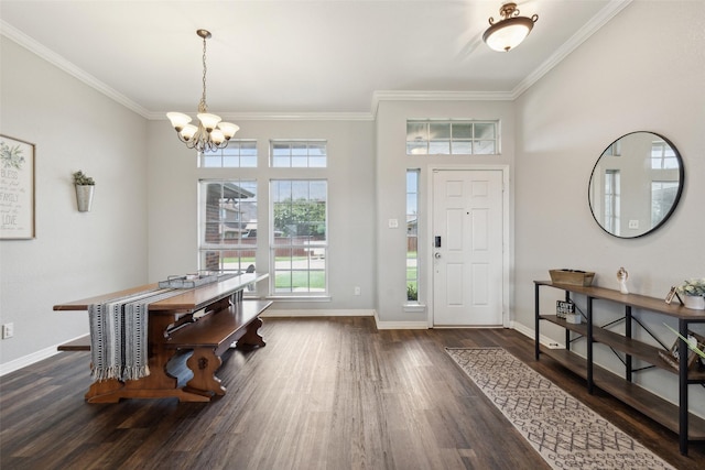 entryway featuring dark hardwood / wood-style flooring, crown molding, and a chandelier